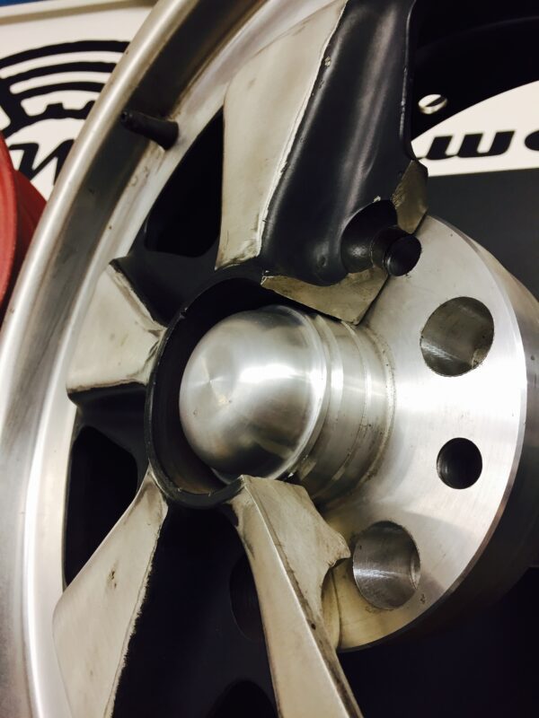 Wagenswest stretched vw bus to Porsche front hub grease cap on a hub in a wheel